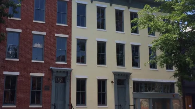 The restored facades of three historic Victorian row-homes on an urban street in Washington, DC
