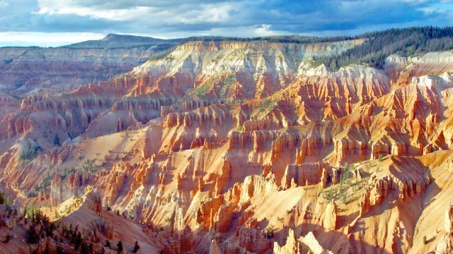 The ground falls away from the viewer creating brilliant rock formations of pink, red, and orange.