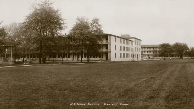 Historic black and white image of a large boarding school campus