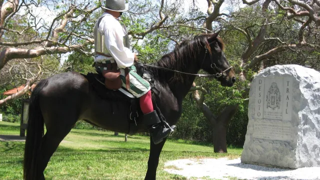 Reenactor Bill Boston on his horse Dixie in front of the De Soto Monument.