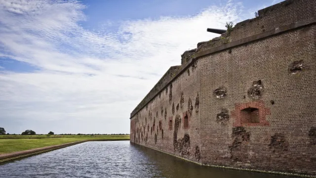 The red masonry walls of Fort Pulaski still show battle damage over 150 years later.