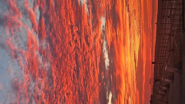 Red pink and orange sky over a body of water