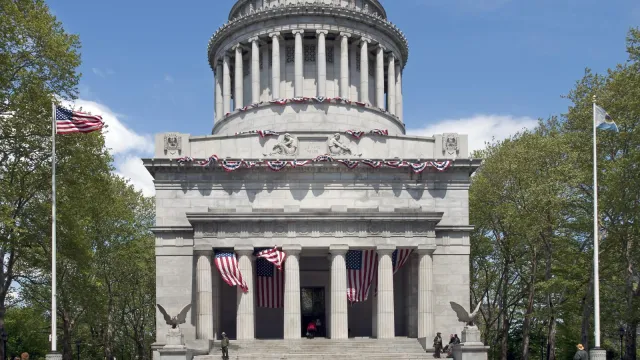 Mausoleum and flags in sunny weather