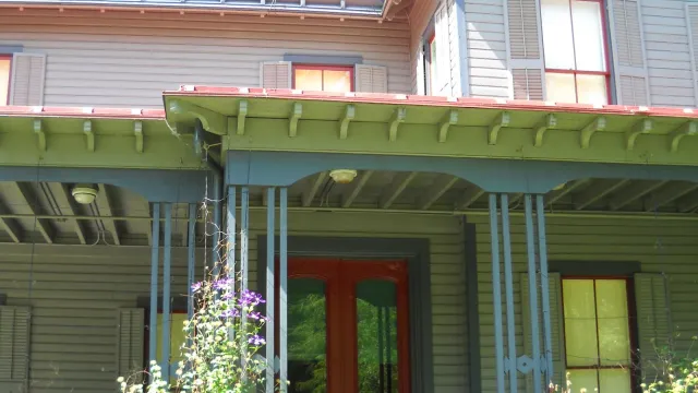 Front porch of Garfield home showing red front door