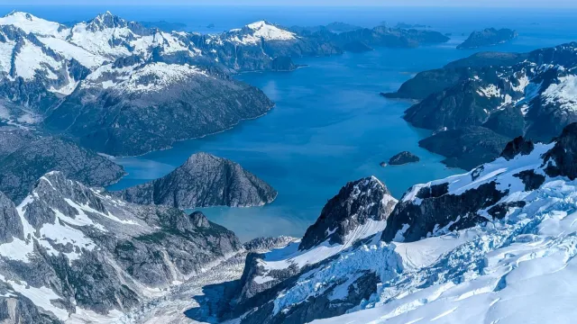 A thin bay surrounded by mountains and ice
