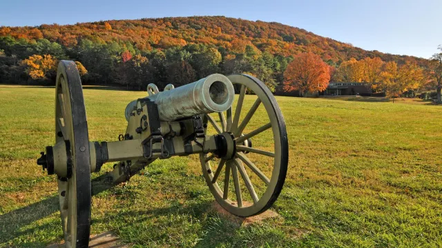 Cannon with front field and Visitor Center in background.