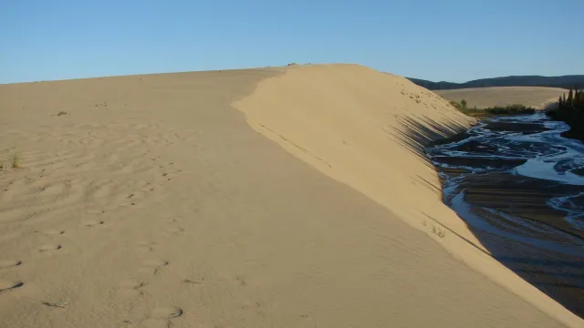 sun setting on sand dunes