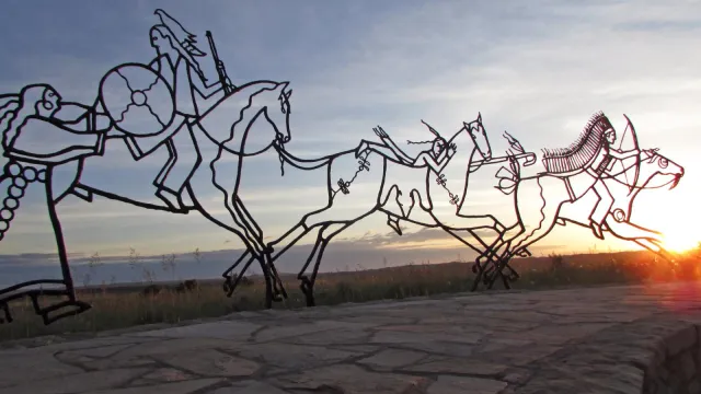 The sun sets behind the Indian Memorial.