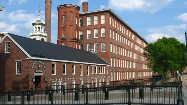 5 story brick factories with a clocktower surrounding a central courtyard