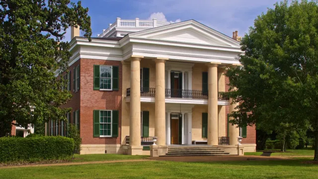 Two story brick mansion with columns