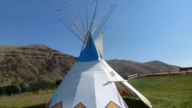 Colorful painted tipi on green lawn