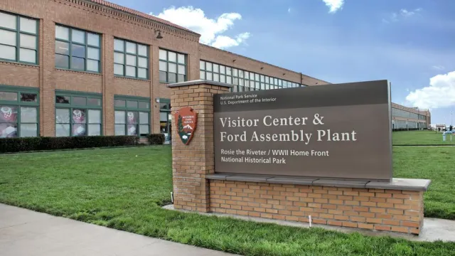 Entrance sign against the historic Ford buidling.