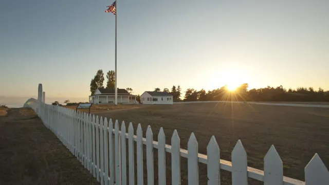 a sun setting behind historic parade grounds