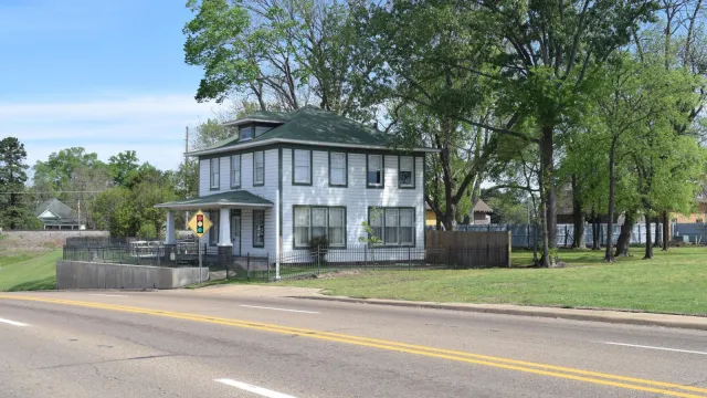 The birthplace home of President Bill Clinton illuminated at dusk.